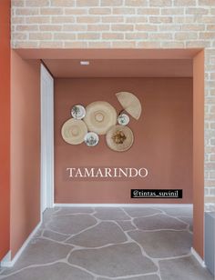 the entrance to tamarindo's new restaurant, with its stone floor and brick wall