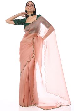 Featuring an onion pink saree in organza base with scallop embroidery. It is paired with a contrasting madras silk emerald blouse.   FIT: Fitted at bust and waist.  COMPOSITION: Organza, Madras silk. CARE: Dry clean only. Pink Organza Saree, Onion Pink, Emerald Green Blouse, Embroidered Saree, Embellished Jacket, Contrast Blouse, Stylish Sarees, Blouse For Women, Embroidered Neckline