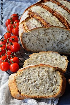 sliced loaf of bread with tomatoes on the side