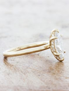 a yellow gold engagement ring with an oval cut diamond