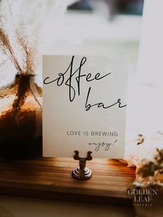 a coffee bar sign sitting on top of a wooden table