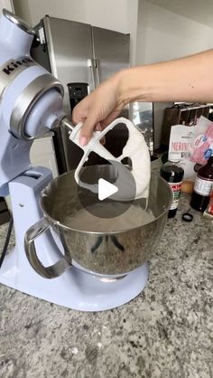 a person using a mixer to make something