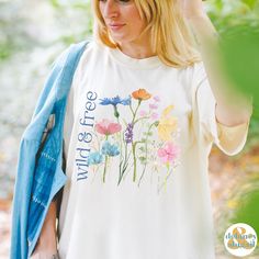 Get ready to be OBSESSED with your new Wildflowers shirt. It's the cutest and most trendy way to emit all those important free spirit vibes! This is the perfect wild & free tshirt! Great gift for the free spirit in your life! Comfort Colors introduces the soft-washed, 100% ring-spun cotton, garment-dyed fabric that brings extra coziness to your wardrobe while the relaxed fit makes it an excellent daily choice. The double-needle stitching throughout the tee makes it highly durable while the lack of side-seams helps the shirt retain its tubular shape.  ❤ The Comfort Colors 1717 tee is made with medium fabric (6.1 oz/yd² (206.8 g/m      consisting of high quality, 100% ring-spun US cotton for long-lasting comfort. ❤ The relaxed fit keeps the wearer comfy in both casual and semi-formal setting Cute Multicolor T-shirt For Spring, Spring Relaxed Fit T-shirt With Watercolor Print, Spring Graphic Tee With Screen Print, Botanical Screen Print Tops For Spring, White Watercolor Print T-shirt For Spring, Botanical Style Screen Print Tops For Spring, Multicolor Watercolor Print T-shirt For Spring, Spring Graphic Tee Shirt With Screen Print, Summer Watercolor Print Graphic Tee