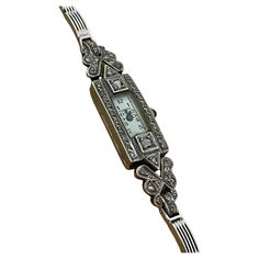 This ladies' cocktail watch was made by Swiss brand Festina, it's from Art-Deco period, yet it's in beautiful vintage condition & in excellent working order. It features: Lavishly decorated with marcasites desirable rectangular hinged Case, performed in Sterling Silver Case measures 11mm x 31mm (from lug to lug). Completed by cabochon synthetic sapphire crown Joint to a 9K White Gold bracelet, an adjustable clasp is bearing a 375 stamp & London hallmark max circumference is 18.5cm Swiss Manual Movement Comes in a box, accompanied by valuation certificate & 6 months warranty Sapphire Crown, Swiss Art, Cocktail Watch, Ladies Dress Watches, White Gold Bracelet, Art Deco Period, Gold Case, Women Wrist Watch, Diamond Art