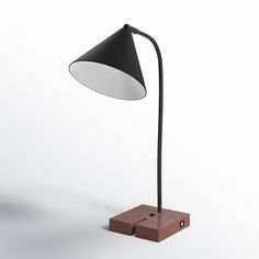 a black and white lamp sitting on top of a wooden block