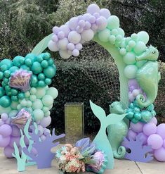 an arch made out of balloons and mermaid decorations