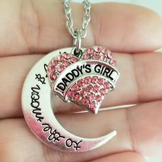 New Handmade Daddy's Girl Charm Necklace Celebrate Your Special Bond With This Beautiful Handmade Necklace. Silver Plated Pink Crystal 'Daddy's Girl' Charm With An Engraved 'To The Moon And Back' Crescent Moon Charm. 18 Inch Chain With Lobster Clasp Closure. Ships Within 24 Hours Of Purchase Monday-Saturday Daughter Gift, Daughter Christmas, Daughter Jewelry, Daughter Birthday, Father Daughter Personalized Pink Jewelry For Christmas, Personalized Pink Jewelry For Father's Day, Cute Silver Jewelry For Birthday Gift, Cute Silver Jewelry For Gifts, Cute Silver Jewelry For Mother's Day, Silver Necklace For Birthday And Christmas, Jewelry Daughter, Mom Daughter Jewelry, Pink Heart Pendant