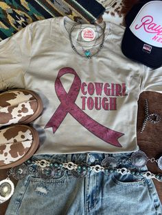 The "Cowgirl Tough Pink Ribbon" Graphic Tee is a perfect blend of Western spirit and support! Featuring a stylish pink ribbon with a cowgirl hat and boots, this tee celebrates the strength and courage of those battling breast cancer. Show your support with a little cowgirl flair and let everyone know you're riding for a cause! Unisex fit  Made in the USA Ribbon Graphic, Womens Jumpsuits, Cowgirl Hat, Cowgirl Hats, Plus Size Shopping, Everyone Knows, Pink Ribbon, Short Tops, Long Sleeve Sweater