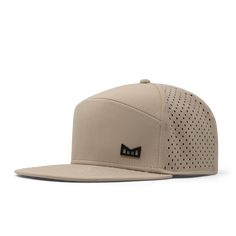 The angled view of melin's Trenches Icon Hydro - Khaki Sports Functional Flat Brim Baseball Cap, Functional Sports Baseball Cap With Flat Brim, Sports Baseball Cap With Flat Brim, Functional Baseball Cap With Flat Brim For Sports, Lightweight Flat Brim Sports Hats, Functional Adjustable Snapback Hat, Functional Adjustable Snapback Visor Hat, Adjustable Snapback Visor Hat, Adjustable Functional Snapback Visor Hat