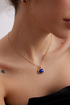 Sophisticated Blue Necklace with Gold-Framed Oval Lapis Lazuli Royal Blue Jewelry For Gifts, Royal Blue Jewelry For Gift, Royal Blue Jewelry Gift, Elegant Blue Jewelry With Delicate Chain, Elegant Blue Round Pendant Necklace, Minimalist Blue Clavicle Chain Necklace, Blue Lapis Lazuli Round Necklace, Elegant Royal Blue Necklace For Gift, Classic Royal Blue Oval Jewelry