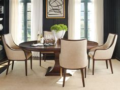 a dining room with black walls and white curtains