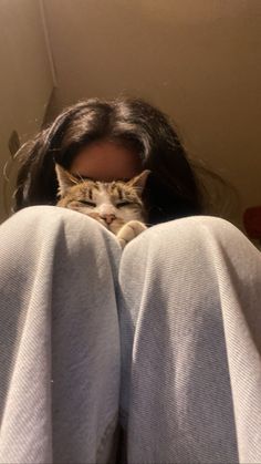 a woman laying on her back with a cat in her lap behind her head and the caption reads, i'm not sure what you are doing