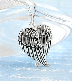 Heart-Shaped Folded Angel Wings Locket – Blank Inside | woot & hammy thoughtful jewelry Heart-shaped Angel Wings Jewelry Gift, Silver Engraved Wing-shaped Jewelry, Engraved Wing-shaped Silver Jewelry, Silver Wing-shaped Necklace For Valentine's Day, Silver Hallmarked Heart Necklace For Wedding, Sterling Silver Heart Jewelry With Angel Wings, Angel Wings Locket Necklace, Angel Wings Necklace, Angel Wings Jewelry