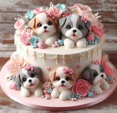 there is a cake decorated with three dogs on the top and two puppies on the bottom