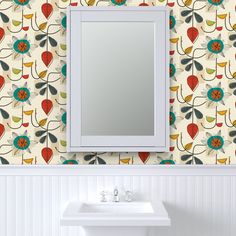 a white sink sitting under a bathroom mirror next to a wall mounted faucet