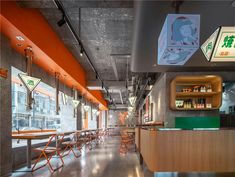 an empty restaurant with orange and green accents