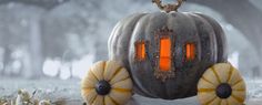 a pumpkin shaped lantern sitting on top of a table