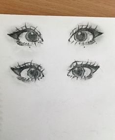 a drawing of four eyes with one eye opened and the other half closed, on top of a piece of paper