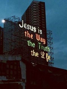 a neon sign that reads jesus is the way, the truth in the life on top of a building