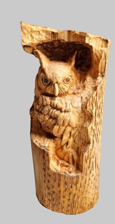 an owl carved into a piece of wood