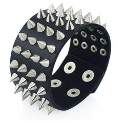 Four Row Spiked Metal Cuff. Black faux leather heavy metal clasp cuff wristband with four rows of spikes. A classic punk/metal accessory for any gender. Length: 22.5cm/8.9" Width: 4cm/1.6" Adjustable clasp closure. Punk Cuff Bracelets With Rivets, Punk Style Leather Cuff Bracelet, Black Edgy Wristband With Studs, Edgy Black Leather Bracelet With Spikes, Punk Style Leather Bracelet With Rivets, Punk Leather Bracelet With Rivets, Punk Black Bracelets With Studs, Punk Black Bracelets With Spikes, Black Punk Bracelets With Studs