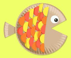 a paper plate shaped like a fish with yellow and orange circles on it's side