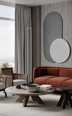 a living room filled with furniture next to a large window and a round mirror on the wall