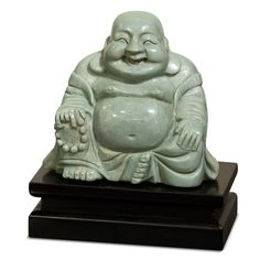 a white buddha statue sitting on top of a black base