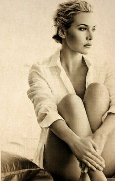 a black and white photo of a woman with her legs crossed