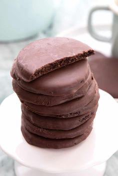 a stack of chocolate cookies sitting on top of a white plate