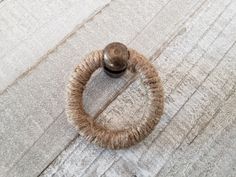 a ring on the floor with a door knob attached to it's center piece