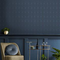 a living room with blue wallpaper and gold accents, including a chair in the foreground