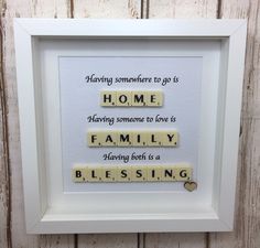 a scrabble tile frame with words that say home, having someone to love is family having both in a blessing