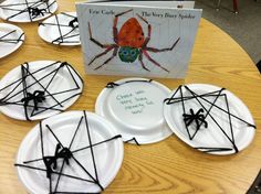 paper plates with black string wrapped around them and a book on the table in front of them