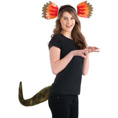 a girl in black shirt holding an orange and red bird on her head with wings