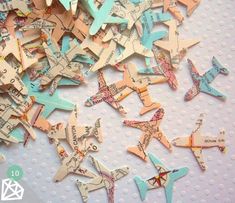 many small airplanes are scattered together on the table