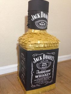 a jack daniels bottle sitting on top of a wooden floor