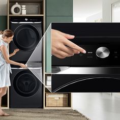 a woman standing in front of a washer and dryer with her hand on the door