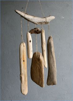 some driftwood pieces hanging from a rope