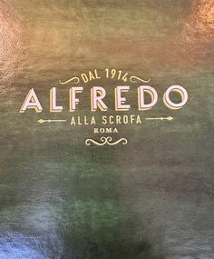 the back of a shirt that says alfredo alla scropa roma in gold lettering