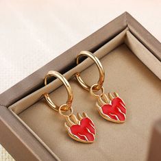 Look stunning with these Hot Red Flaming Heart Charm Hoop Earrings. These hoops feature a delicate heart charm for a unique but subtle look. Show off your style and charm with these beautiful earrings.Material: Stainless steel. Red Heart Charm Metal Earrings, Trendy Red Metal Hoop Earrings, Valentine's Day Small Hoop Earrings With Heart Charm, Metal Heart Hoop Earrings With Heart Charm, Heart-shaped Metal Hoop Earrings With Heart Charm, Metal Hoop Earrings With Double Heart Charm, Metal Hoop Earrings With Heart Charm For Valentine's Day, Valentine's Day Metal Hoop Earrings With Heart Charm, Valentine's Day Rose Gold Hoop Earrings With Heart Charm