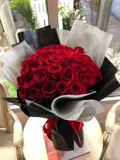 a bouquet of red roses sitting on top of a table