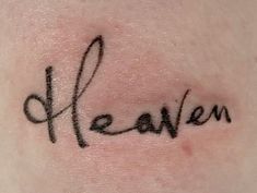 the word heaven written in cursive writing on someone's back side arm