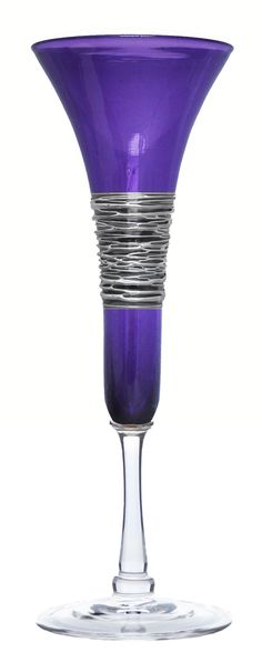 a purple wine glass sitting on top of a table