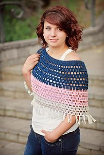 a woman wearing a crocheted shawl with fringe