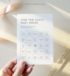 a hand holding up a printable bridal checklist on top of a table