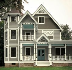 a gray house with white trim on the front and side windows, in an image from instagram