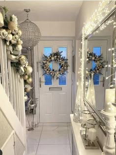 a hallway decorated for christmas with wreaths and lights