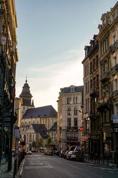 an empty city street lined with tall buildings