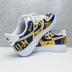 Show Your School Spirit with Custom Hand-Painted Air Force 1s! Rep your favorite NCAA team in style with these one-of-a-kind, hand-painted Air Force 1s! Forget generic merch, these shoes are a canvas for your ultimate fandom. We'll work with you to capture your team's unique spirit, incorporating their colors, mascot, or even your favorite player's number. No detail is too small! Each pair is a labor of love, meticulously hand-painted by skilled artists using high-quality, Angulus Paints. These Custom Artwork Sneakers For Sports, Custom Hand Painted Yellow Sneakers, Sporty Hand Painted Custom Sneakers, Custom Sneakers With Artwork For Sports, Custom Hand Painted Sports Sneakers, Painted Air Force 1, High School Graduation Pictures, The Ivy League, Air Force 1 Sneakers